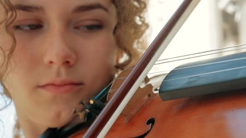 Young Adult Playing Violin Outdoors Close Up