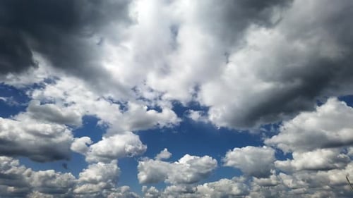 Dramatic White Clouds Drifting Across Blue Sky