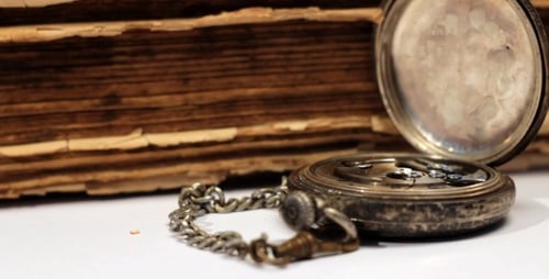 Antique Pocket Watch and Old Book
