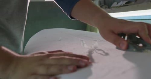 Männlicher Surfbrettmacher in seiner Werkstatt