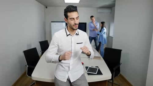 Young Adult Celebrates in Bright Modern Office