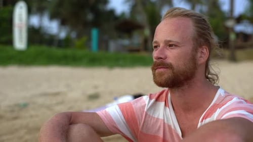 Man Smiles on Sandy Beach Vacation