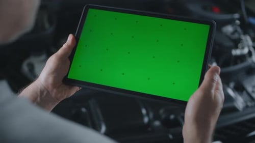 Male Car Service Worker Swiping on Tablet