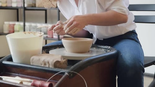 Woman Forming Clay Bowl on Pottery Wheel