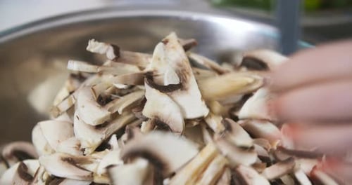 Chopping Fresh Mushrooms in Kitchen for Cooking