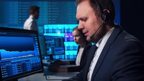 Team of brokers is working in office using workstation and analysis technology.