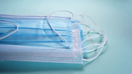 Close Up of Stacked, Blue Disposable Face Masks