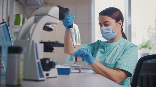 Scientist Handling Blood Sample in Medical Lab
