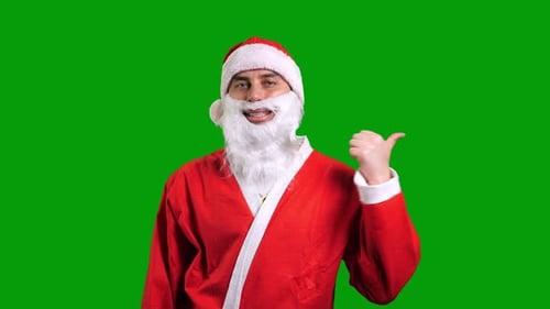 Santa Claus in Red Suit Pointing Aside on Green Chroma Key Background