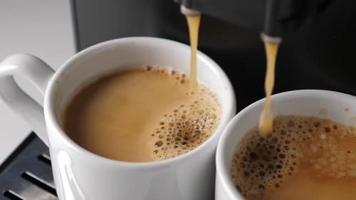 Espresso Machine Pouring Coffee into Two Mugs