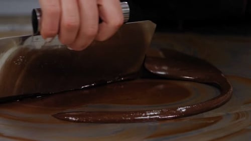 Tempering of the Chocolate on the Metal Surface in the Pastry Shop