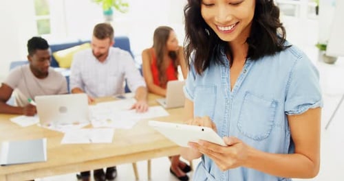 Female executive using digital tablet in the office
