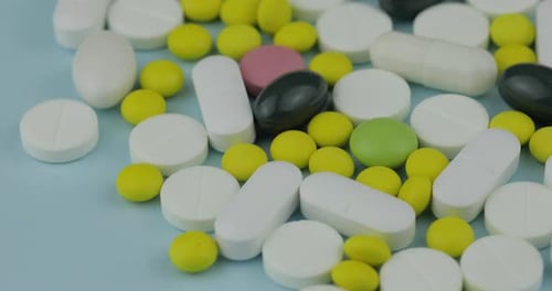 Assorted Pills and Capsules on Light Blue Surface