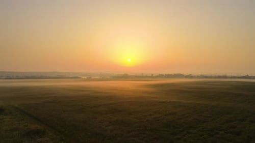 Aerial Landscape View of Sunny Morning Over Foggy Green Fields
