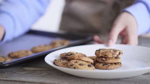 Stacking Chocolate Chip Cookies on White Plate