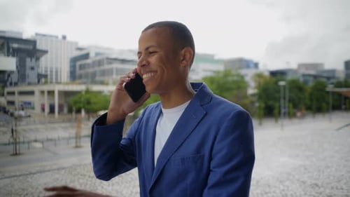 Young Adult Talking on Smartphone in City