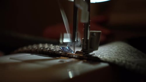 On a Sewing Machine Sew Clothes Close-up. Dressmaker Sews Fabric.