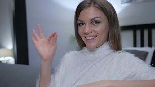 Woman Giving "OK" Hand Gesture Smiling