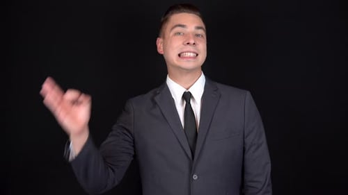 Man in Suit Makes OK Sign