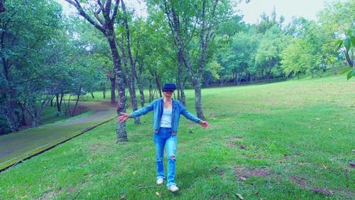 Woman Uses VR Headset in Green Urban Park