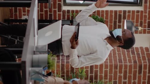 Professionals in Masks Conferencing via Tablet in Office