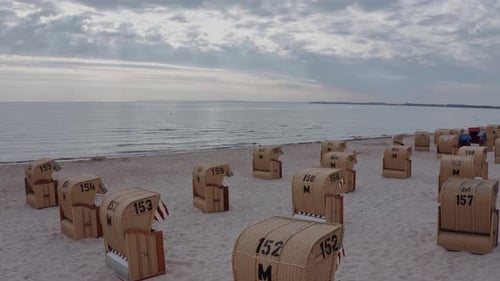 Evening seascape inspiring serenity and silence with spread beach chairs on a desolate beach under a