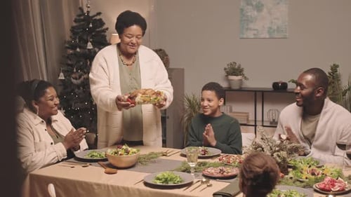 Family Celebrates Christmas Dinner Together at Home