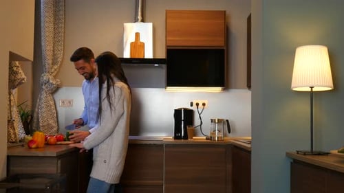 Man and Woman Cooking Together in Kitchen