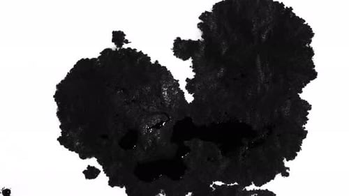 Black Ink Spreads Across White Surface