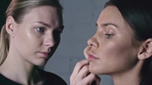 Makeup Artist Applying Makeup to a Model