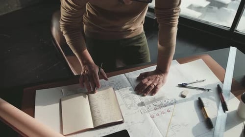 Hipster Engineer arbeitet mit Blueprint. Von oben schießen