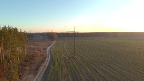 Flying Over Wires Along a High-voltage Power Line Against the Backdrop of Picturesque Autumn Nature