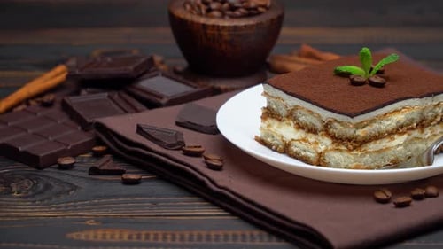 Portion of Traditional Italian Tiramisu Dessert and Pieces of Chocolate Bar