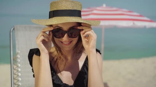 Woman Relaxes on Beach Vacation