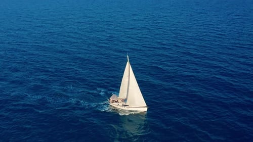 Sailboat in the Ocean. White Sailing Yacht in the Middle of the Boundless Ocean