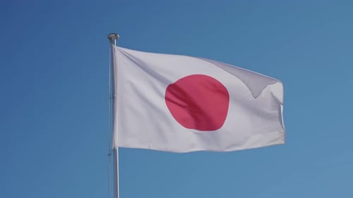 Japanese Flag Waving in the Wind on Clear Day