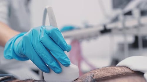 Doctor Doing Abdominal Ultrasound to a Man in a Modern Clinic
