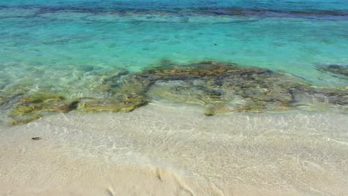 Daytime fly over abstract view of a summer white paradise sand beach and turquoise sea background in