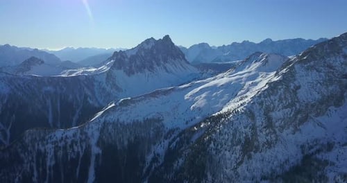 Aerial drone view of snow covered mountains in the winter.