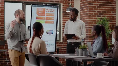 Adults Collaborate During Business Meeting in Urban Office