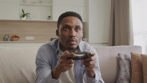 Man Energetically Playing Video Game at Home