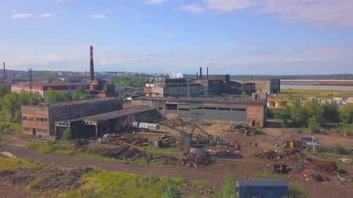 A large factory with pipes from which smoke