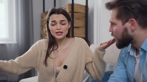 Unhappy Young Couple which Emotionally Finding Out their Relations on the Couch