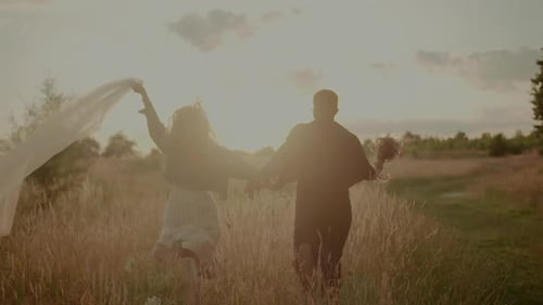 Carefree Young Couple Walking and Smiling on Holiday on Countryside Freedom and Happiness Concept
