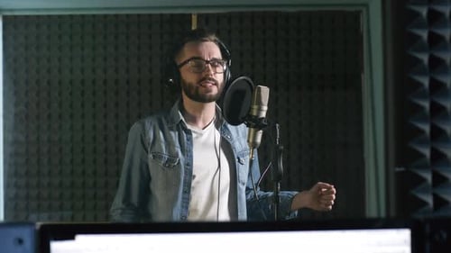 Man Singing into Microphone in Recording Studio