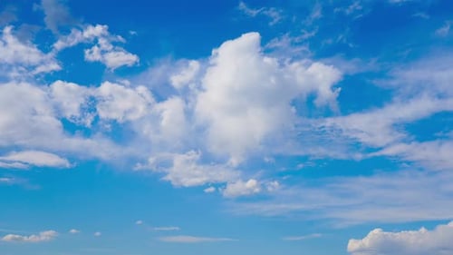Fluffy Clouds Drifting in a Vibrant Blue Sky