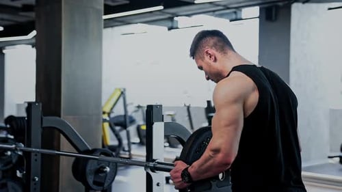 Man Bodybuilding Weight Lifting in a Gym Fitness Training