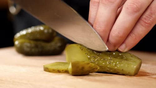 Cutting Glistening Green Pickle Slices with Sharp Knife