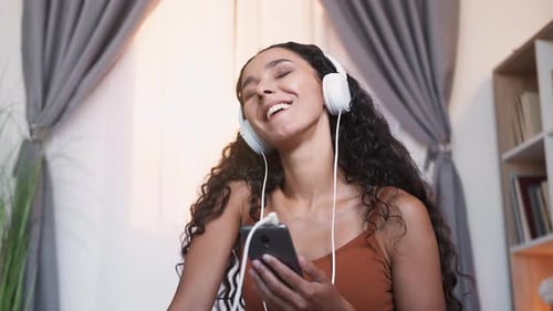 Happy Woman Listening to Music with Headphones