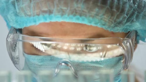 Medical Professional Works with Test Tubes in Lab